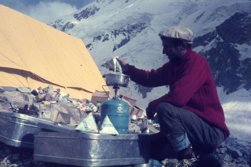 Franc Štupnik-Cicko, a member of the Yugoslav expedition to Hindukush, warming up Alpine milk, in a base kamp in Hindukush, 1968. Photo: Aleš Kunaver, original diapositive kept by the National Museum of Contemporary History, Ljubljana, Slovenia.